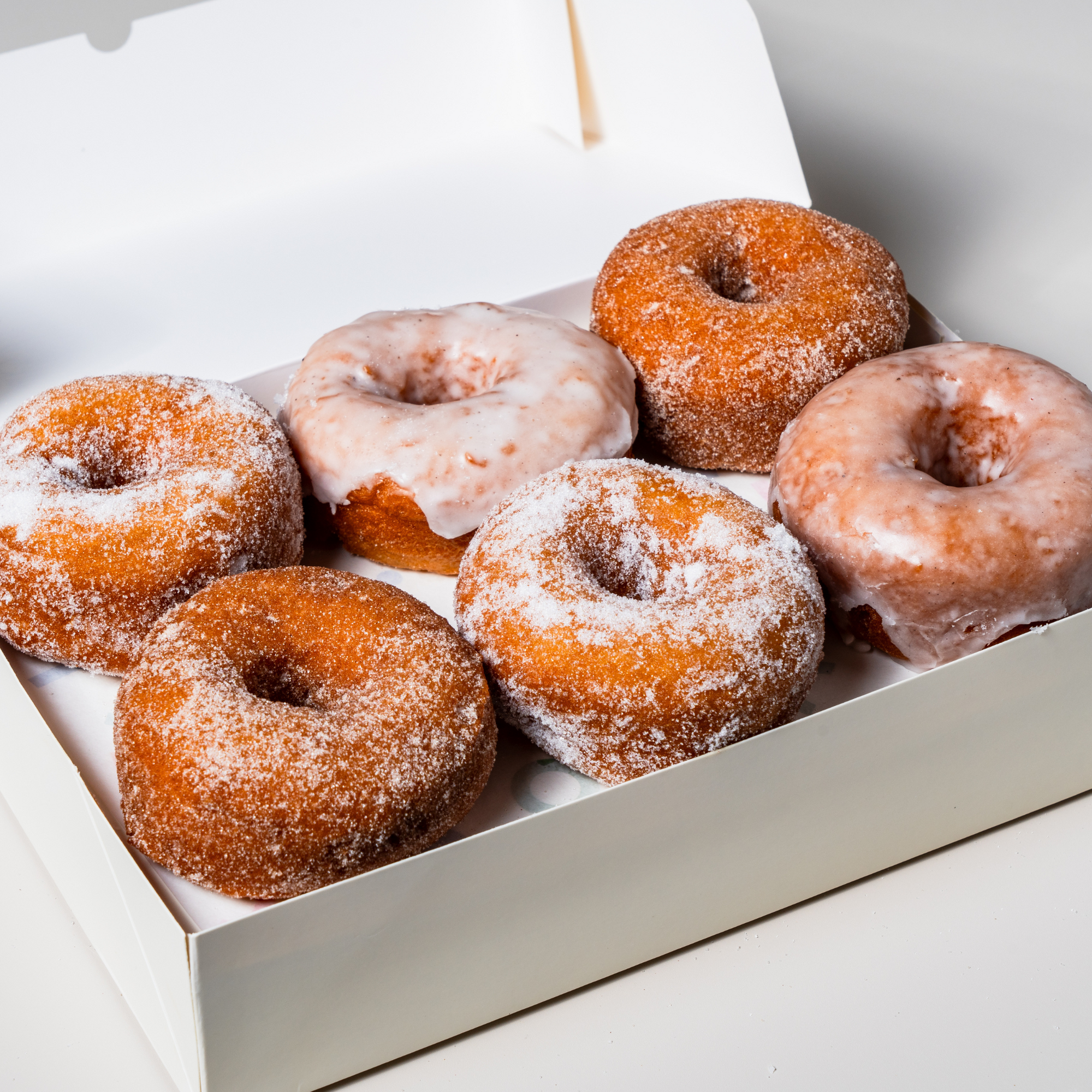Box of gluten-free, vegan glazed ring doughnuts