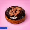 Gluten free vegan fried chocolate crunch doughnut, dark chocolate icing topped with chocolate biscuit pieces