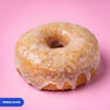 Gluten free vegan fried original glazed ring doughnut under a glossy vanilla glaze