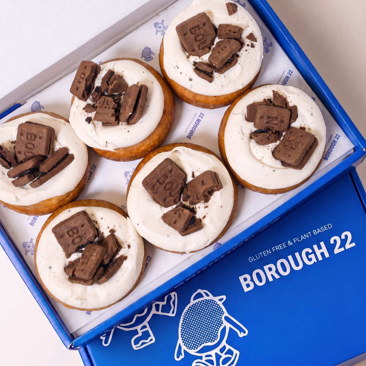 Open Borough 22 box of six gluten free vegan fried cookies and cream doughnuts, topped with vanilla cream and chocolate biscuit pieces