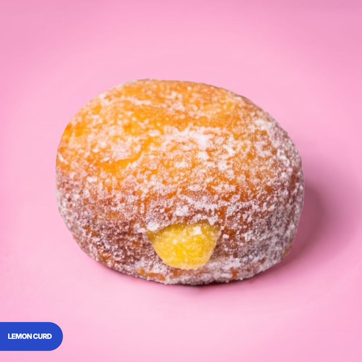 Gluten free vegan fried sugared doughnut filled with lemon curd, the filling visible at the side