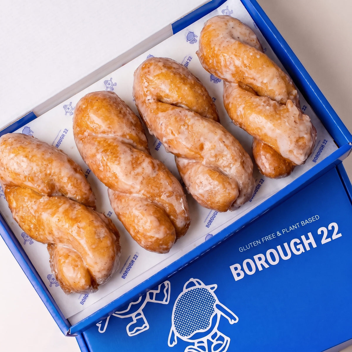 Open Borough 22 box of six gluten free oat free vegan yum yums, twisted doughnut batons under a vanilla glaze