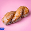 Gluten free oat free vegan yum yum, a twisted doughnut baton under a glossy vanilla glaze